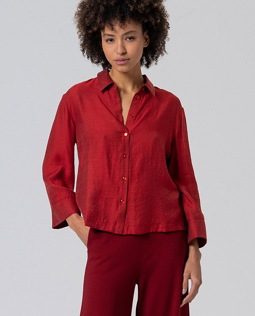 Oversize red cut shirt with relaxed lines, made of soft fabric with a structured drape, wide and marked cuffs,  80% Viscose, 20% Polyamide.