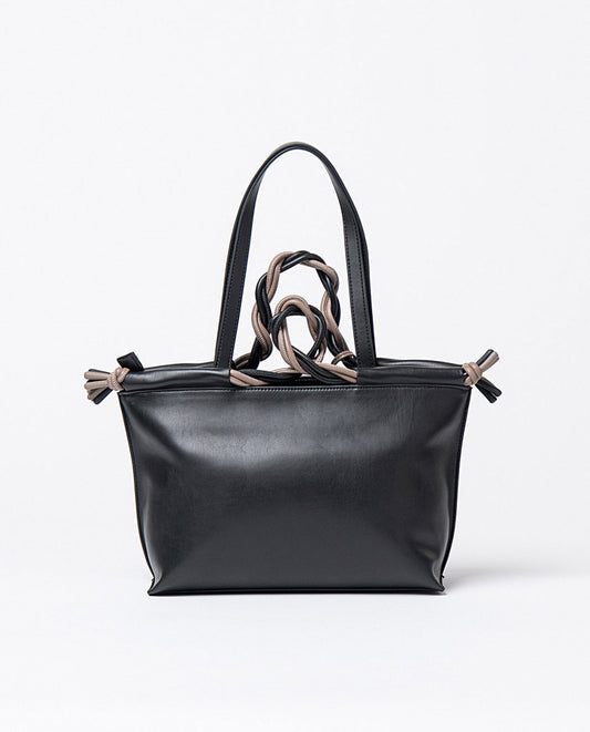 Hand and shoulder black faux leather bag, with details in grey color, top zippered closure and two interior compartments, one open and one with zipper.