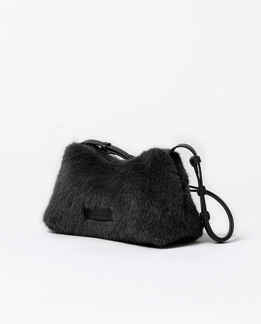 Baguette shoulder faux fur black bag with a multi-position adjustable handle with press studs, top zipper closure, one inner open pocket. Lining.
