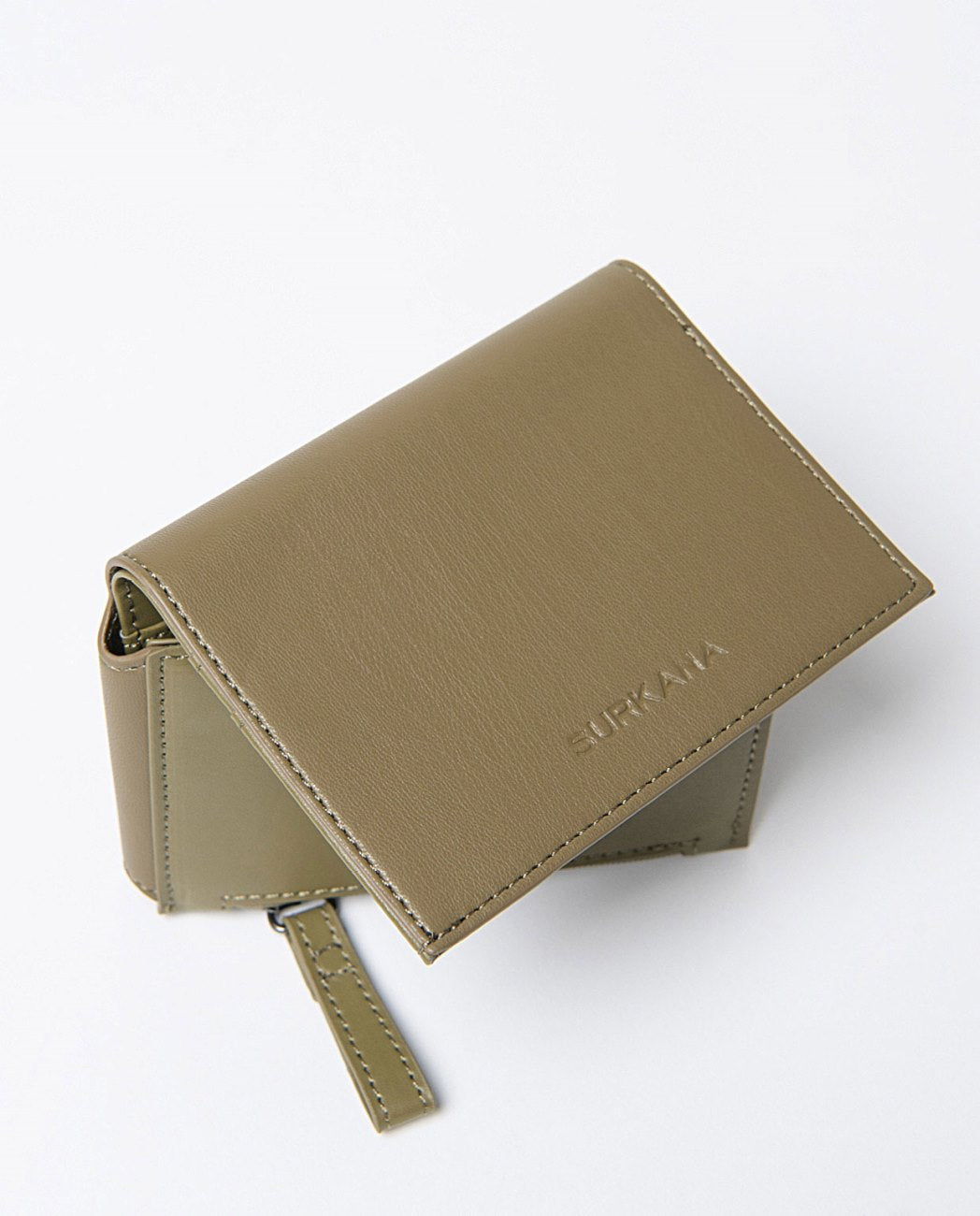 Small compact wallet in khaki faux leather, includes compartments for cards, a zippered pocket and snap button closure. 