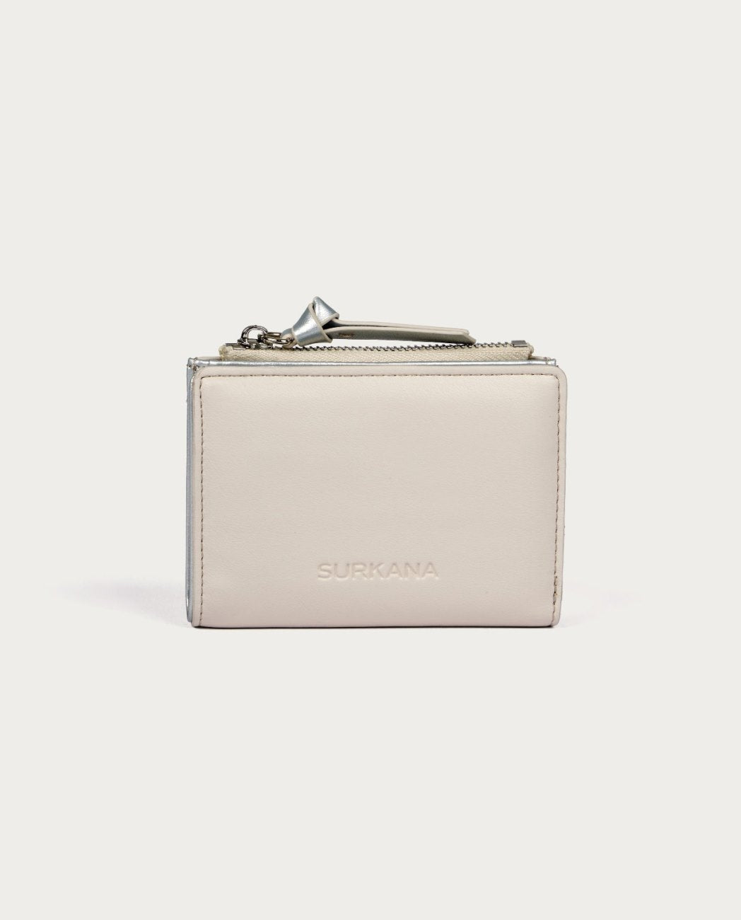Small white wallet with zip compartment and inside metallic color.