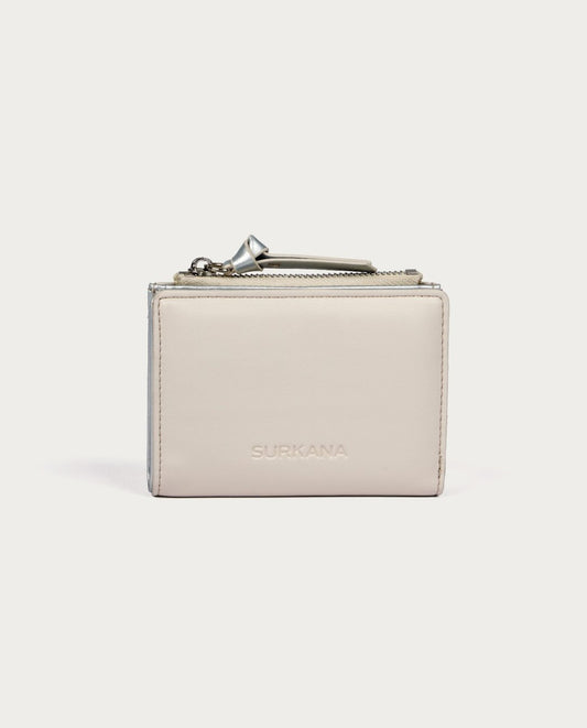 Small white wallet with zip compartment and inside metallic color.
