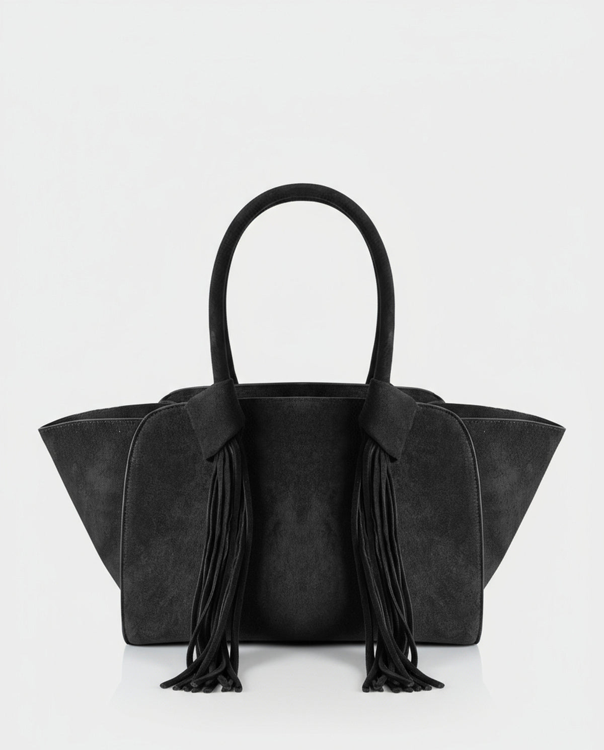 Shopper black  in soft suede effect with a structured winged silhouette. Double handles finished with long fringing that adds movement. Inner open pocket and zip pocket, 30cm x 23cm x 12cm