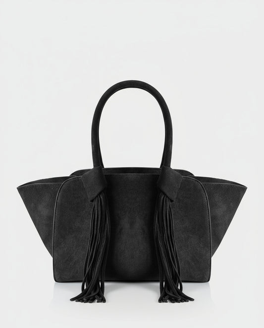 Shopper black  in soft suede effect with a structured winged silhouette. Double handles finished with long fringing that adds movement. Inner open pocket and zip pocket, 30cm x 23cm x 12cm