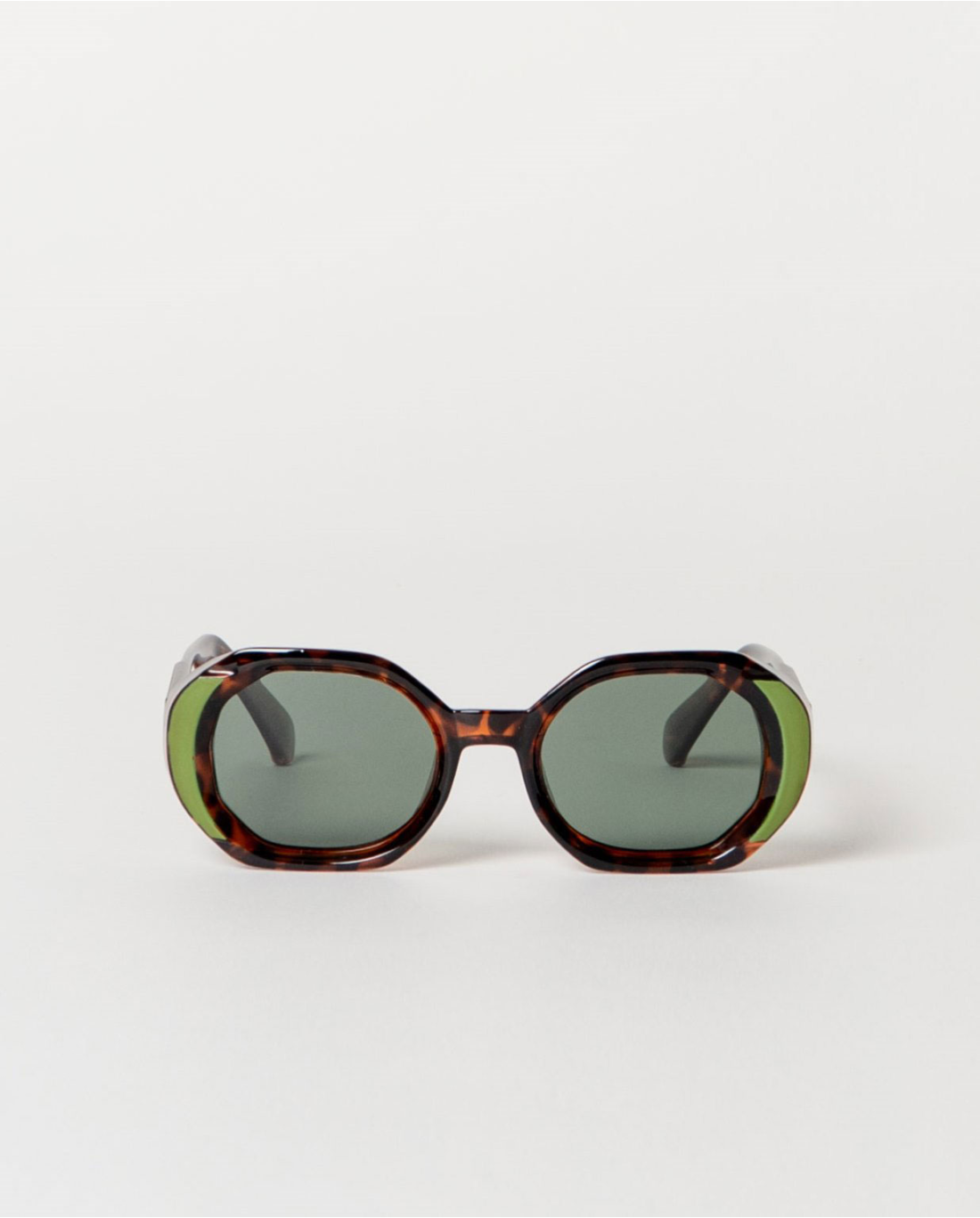 Sunglasses with tortoiseshell frame and green lenses.