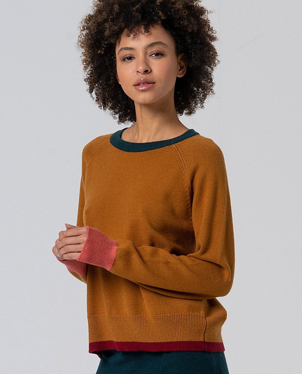 Knitted camel sweater with round neck, dark green collar, coral cuffs and bordeaux hem. Straight cut and long sleeves, in 50%Viscose, 28%Polyester, 22%Polyamide.