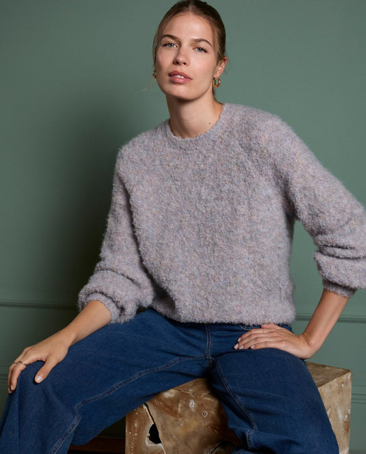 Long-sleeved round neck lavender boucle sweater made of a warm blend of recycled polyester and wool.
