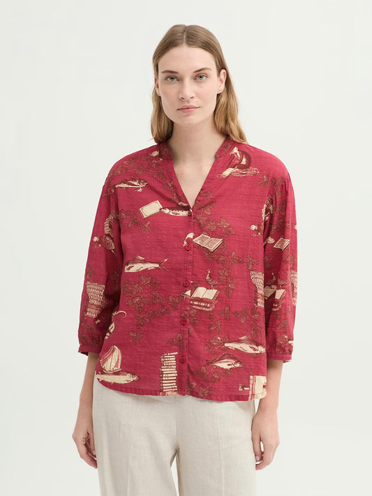 Dark red mandarin Midsummer Books print like leaves, fishes, books, objects in ecru and cinnamon colors, with opening and button front, long puff sleeves with vent, cuff and button.
