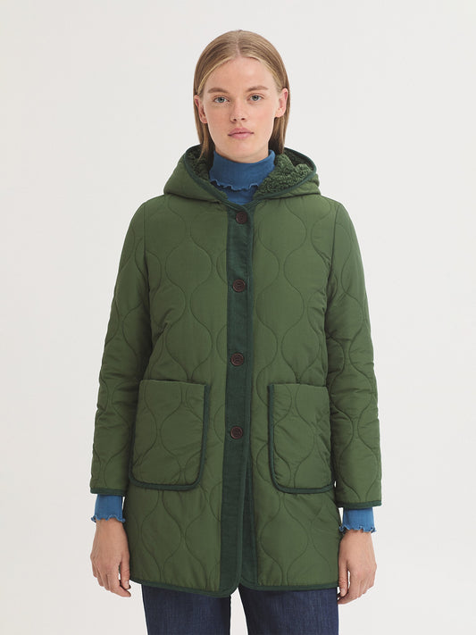 Quilted green trench coat in water repellent nylon blend fabric. Micro corduroy placket and piping. Hood, button front and patch pockets. Lined with sheepskin.
