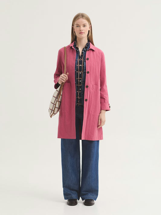Water-resistant intense pink trench coat made of cotton and nylon blend. Featuring a shirt collar, concealed button front and pockets with button. With vent and button at back, and sleeves with folded cuff and button.