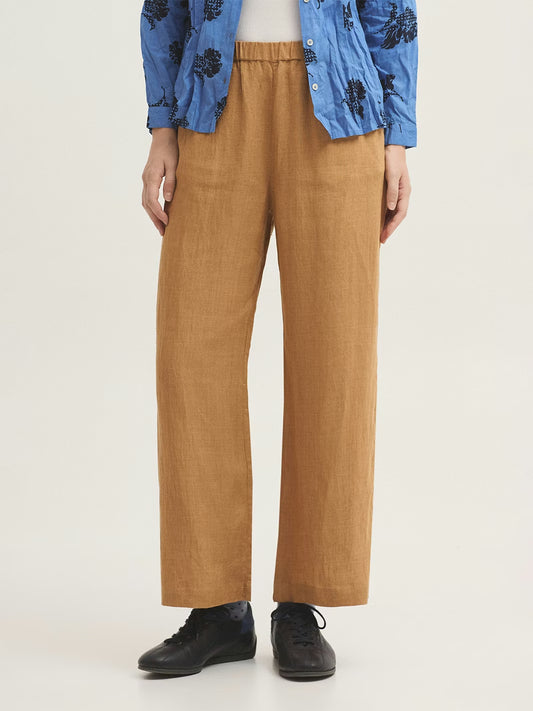 Ochre trousers made of end-on-end 100% linen fabric. With a concealed elasticated waist and a straight leg design.