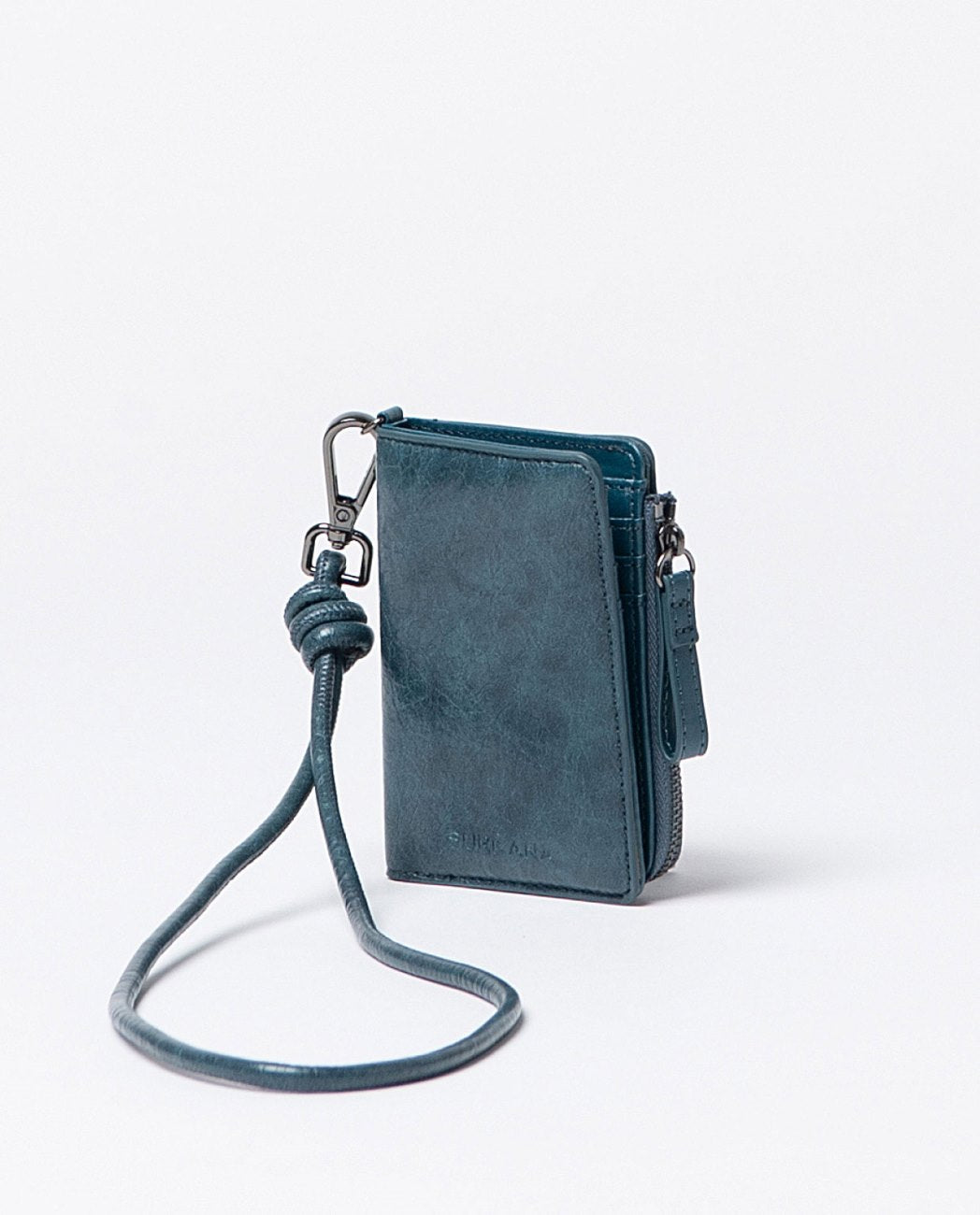 Compact wallet with crackle finish in cobalt blue faux leather, includes compartments for cards, a zippered pocket and snap button closure, with removable strap handle.
