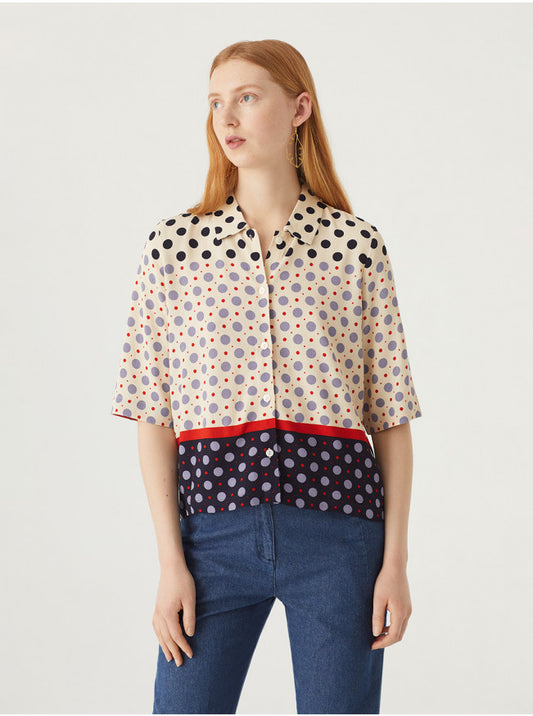 Dots print shirt. Shirt collar and front buttons. Short sleeves. At the top, ecru with dark blue, lavender and small red dots. Red line at the waist. And bottom blue, with lavender and small red dots.  Composition: 100% Viscose